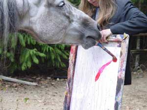 Hadancy hard at work at another painting while Sandy holds the canvas